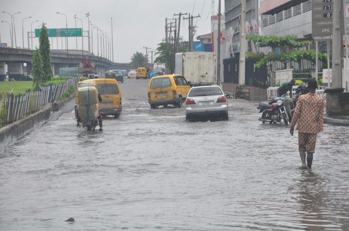 Image result for Lagosians pay N50 to cross flooded road after heavy rainfall